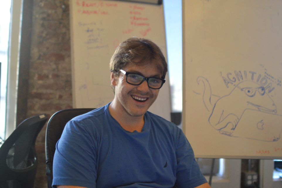 Victor Algaze, smiling in front of a whiteboard